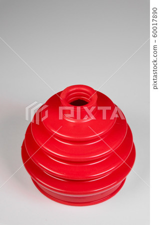 Red automobile axle boots or CV boots on grey gradient background.Spare parts for cars Red automobile axle boots or CV boots on grey gradient background.Spare parts for cars 60017890