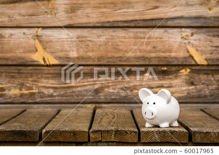 Piggy bank on the weathered wood background 60017965