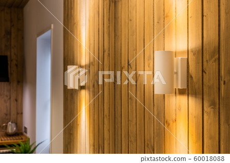 Modern lamps on a wooden wall in the interior of Modern lamps on a wooden wall in the interior of 60018088