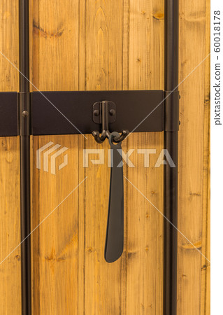Keys and a shoehorn hang on hooks in the hallway. Keys and a shoehorn hang on hooks in the hallway. 60018178