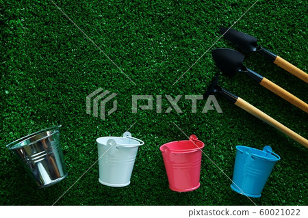 Gardening tools with tin pails or buckets on green grass background 60021022