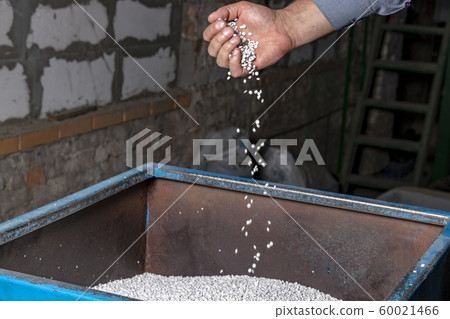 White granules of recycled plastic trash in the White granules of recycled plastic trash in the 60021466