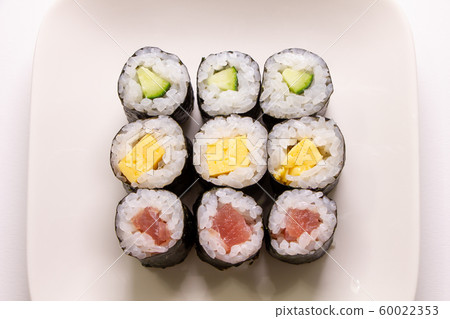 Assorted thin rolls (iron fire, egg, pepper). (White plate, white background, overhead view) Assorted thin rolls (iron fire, egg, pepper). (White plate, white background, overhead view) 60022353