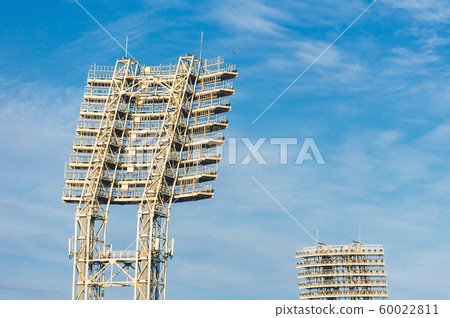 Stadium lights in daytime against blue sky 60022811