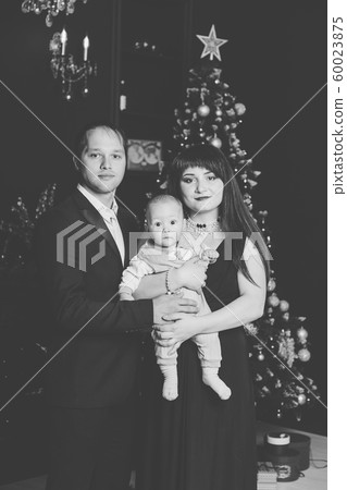 Beautiful happy family of three on New Year's Eve 60023875