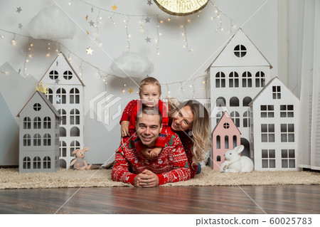Beautiful happy family of three in a New Year's Beautiful happy family of three in a New Year's 60025783