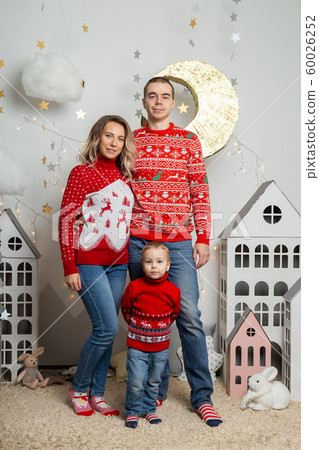 Beautiful happy family of three in a New Year's Beautiful happy family of three in a New Year's 60026252