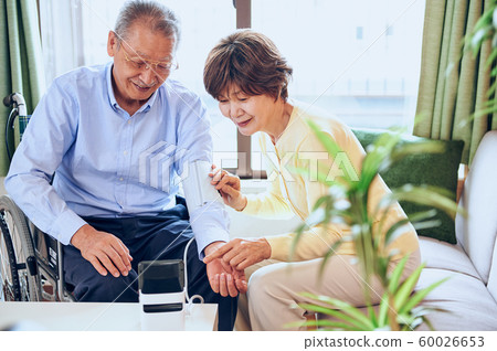 Wheelchair and old couple Wheelchair and old couple 60026653