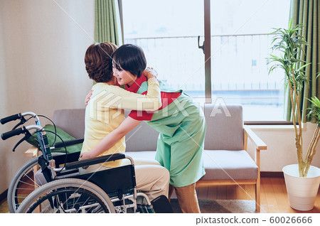 Wheelchair woman and helper Wheelchair woman and helper 60026666