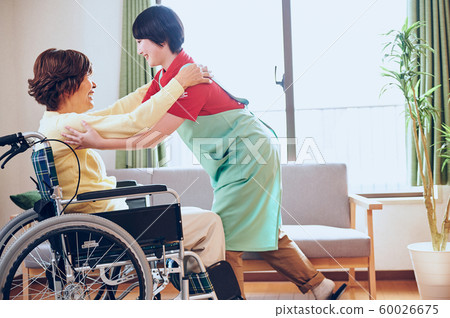 Wheelchair woman and helper 60026675