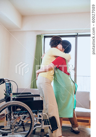 Wheelchair woman and helper 60027089