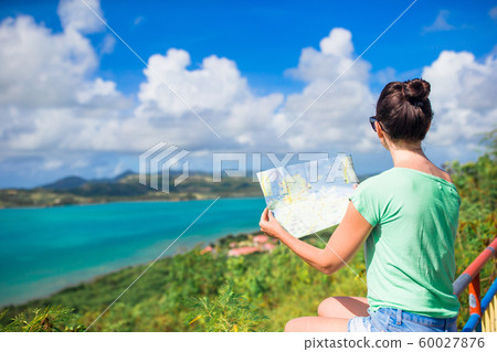 Young tourist woman with view of bay at tropical island in the Caribbean Sea Young tourist woman with view of bay at tropical island in the Caribbean Sea 60027876