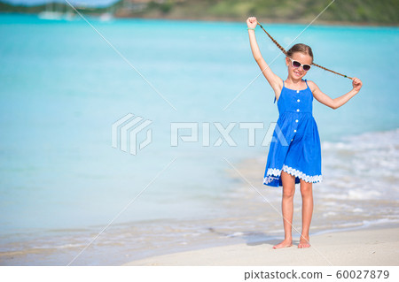 Portrait of beautiful girl on the beach dancing Portrait of beautiful girl on the beach dancing 60027879