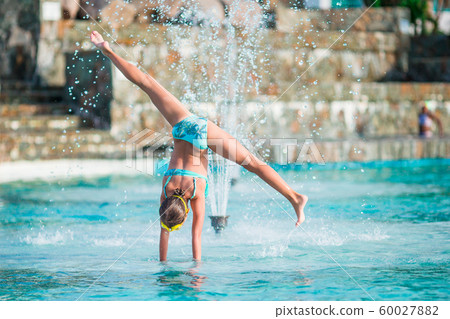 Little adorable girl in outdoor swimming pool Little adorable girl in outdoor swimming pool 60027882
