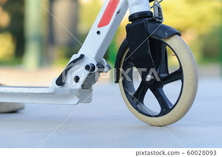 white scooter wheel close up in the Park white scooter wheel close up in the Park 60028093