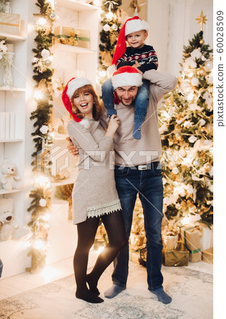 Smiling family with son on couch. Woman and man Smiling family with son on couch. Woman and man 60028509