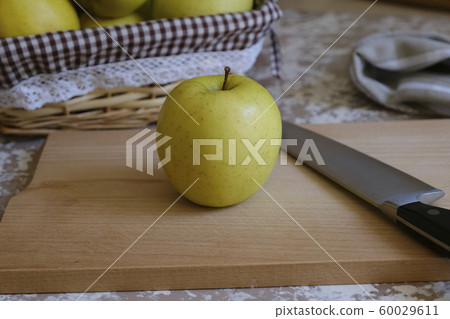 Knife and apple on a cutting board on a table in Knife and apple on a cutting board on a table in 60029611