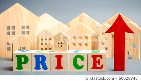 Wooden blocks with the word Price, up arrow and wooden houses. The concept of raising property prices. High cost for rental housing and real estate. Expensive loans to buy an apartment. Analytics 60029746