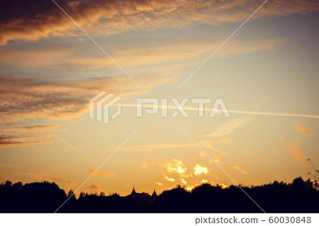 Evening sunset with clouds on the background of the shadows of buildings Evening sunset with clouds on the background of the shadows of buildings 60030848