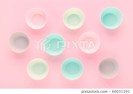 silikone forms for baking muffins and cupcakes on pastel pink background 60031391