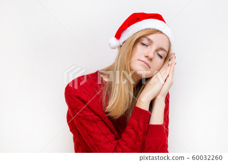 Beautiful woman wearing christmas hat over isolated background smiling doing sleep gesture with hand. Holiday concept. Emotion facial expression. Beautiful woman wearing christmas hat over isolated background smiling doing sleep gesture with hand. Holiday concept. Emotion facial expression. 60032260