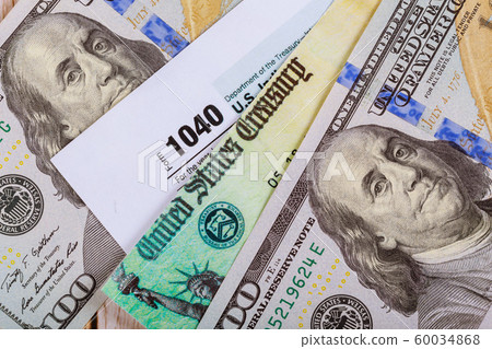 1040 Tax form with refund check and currency US 60034868