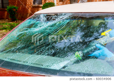 Workers remotion automobile broken windscreen or Workers remotion automobile broken windscreen or 60034906