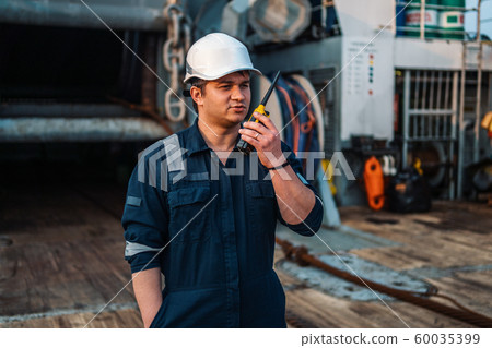 Marine Deck Officer or Chief mate on deck of offshore vessel or ship , wearing PPE personal Marine Deck Officer or Chief mate on deck of offshore vessel or ship , wearing PPE personal 60035399