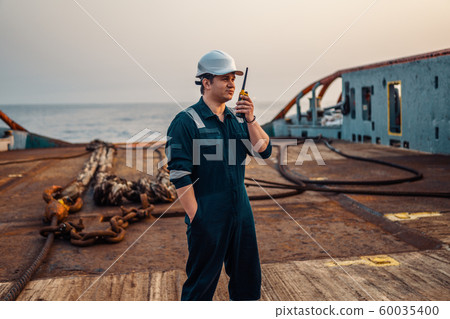Marine Deck Officer or Chief mate on deck of offshore vessel or ship , wearing PPE personal Marine Deck Officer or Chief mate on deck of offshore vessel or ship , wearing PPE personal 60035400