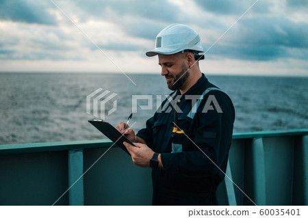 Deck Officer on deck of offshore vessel or ship , wearing PPE personal protective equipment 60035401