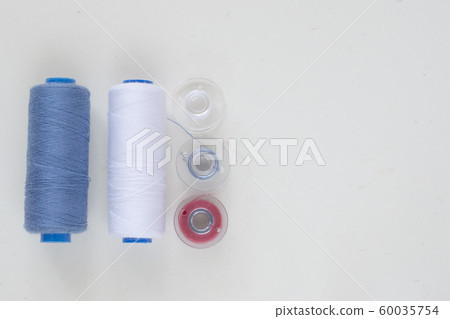 Sewing accessories on a light background close-up. Sewing accessories on a light background close-up. 60035754