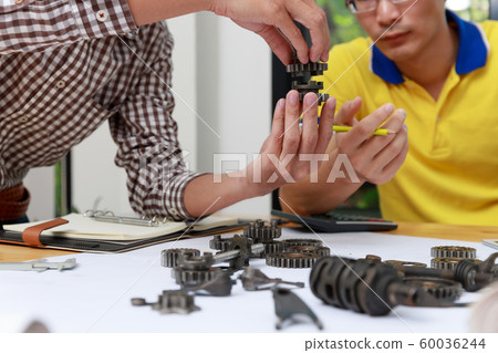 Engineer discussing and designing about mechanical Engineer discussing and designing about mechanical 60036244