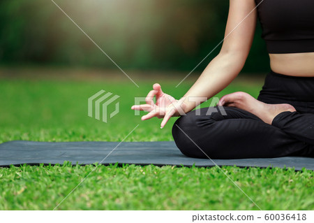 Young Asian woman practicing yoga pose at the park 60036418