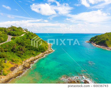 Sea island with turquoise water against blue sky Sea island with turquoise water against blue sky 60036743