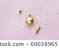Christmas sparkles composition. Christmas ball and golden stars on pastel pink background. 60038965