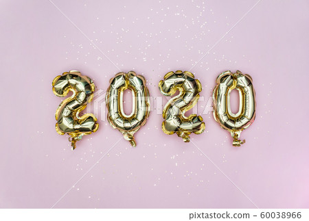 Happy New year 2020 celebration. Gold foil balloons numeral 2020 and golden stars on pastel pink Happy New year 2020 celebration. Gold foil balloons numeral 2020 and golden stars on pastel pink 60038966