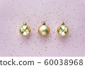 Golden christmas balls and stars on pastel pink background. Christmas sparkles composition. 60038968
