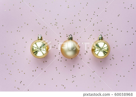 Golden christmas balls and stars on pastel pink background. Christmas sparkles composition. Golden christmas balls and stars on pastel pink background. Christmas sparkles composition. 60038968