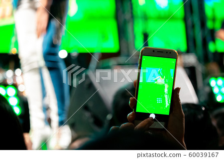 People use mobile phones to live or take pictures People use mobile phones to live or take pictures 60039167