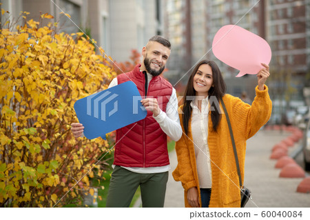 Joyful happy couple participating in social campaign Joyful happy couple participating in social campaign 60040084