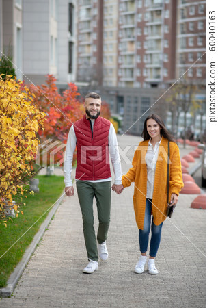 Joyful young people having a romantic walk Joyful young people having a romantic walk 60040163