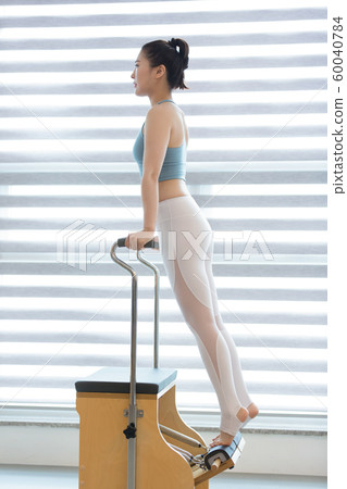 Healthy life, exercising pilates using pilates device 134 60040784