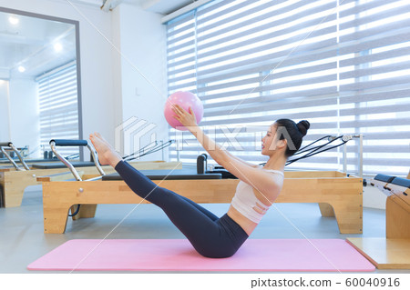 Healthy life, exercising pilates using pilates device 209 60040916