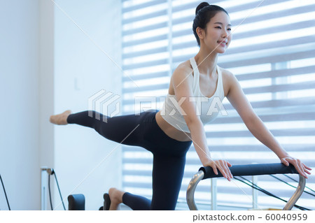 Healthy life, exercising pilates using pilates device 038 60040959