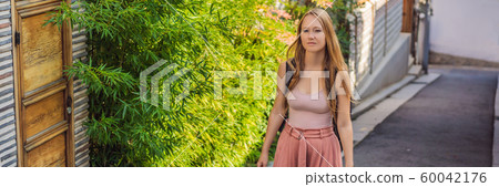 Young woman tourist in Bukchon Hanok Village is one of the famous place for Korean traditional Young woman tourist in Bukchon Hanok Village is one of the famous place for Korean traditional 60042176