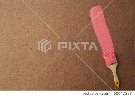 brush with paint to paint the wall paint structure as a background 60042537