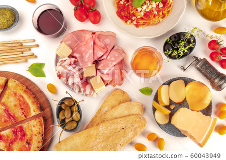 Italian food. Pizza, pasta, cheese, ham, wine, olives, pesto, tomatoes, shot from the top on a white background Italian food. Pizza, pasta, cheese, ham, wine, olives, pesto, tomatoes, shot from the top on a white background 60043949