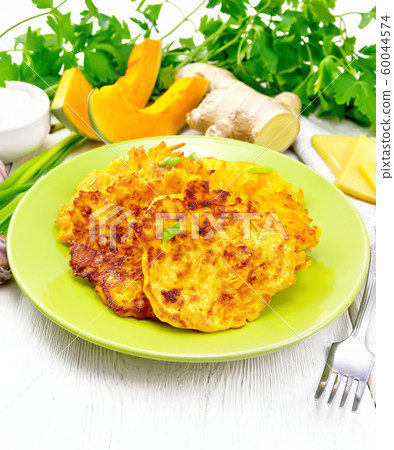 Pancakes of pumpkin with cheese in green plate_2 60044574