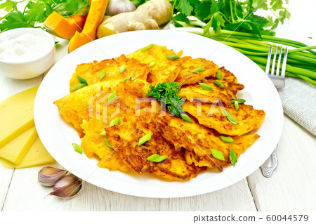 Pancakes of pumpkin with cheese in plate on wooden 60044579