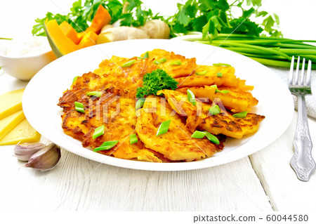 Pancakes of pumpkin with cheese in white plate Pancakes of pumpkin with cheese in white plate 60044580